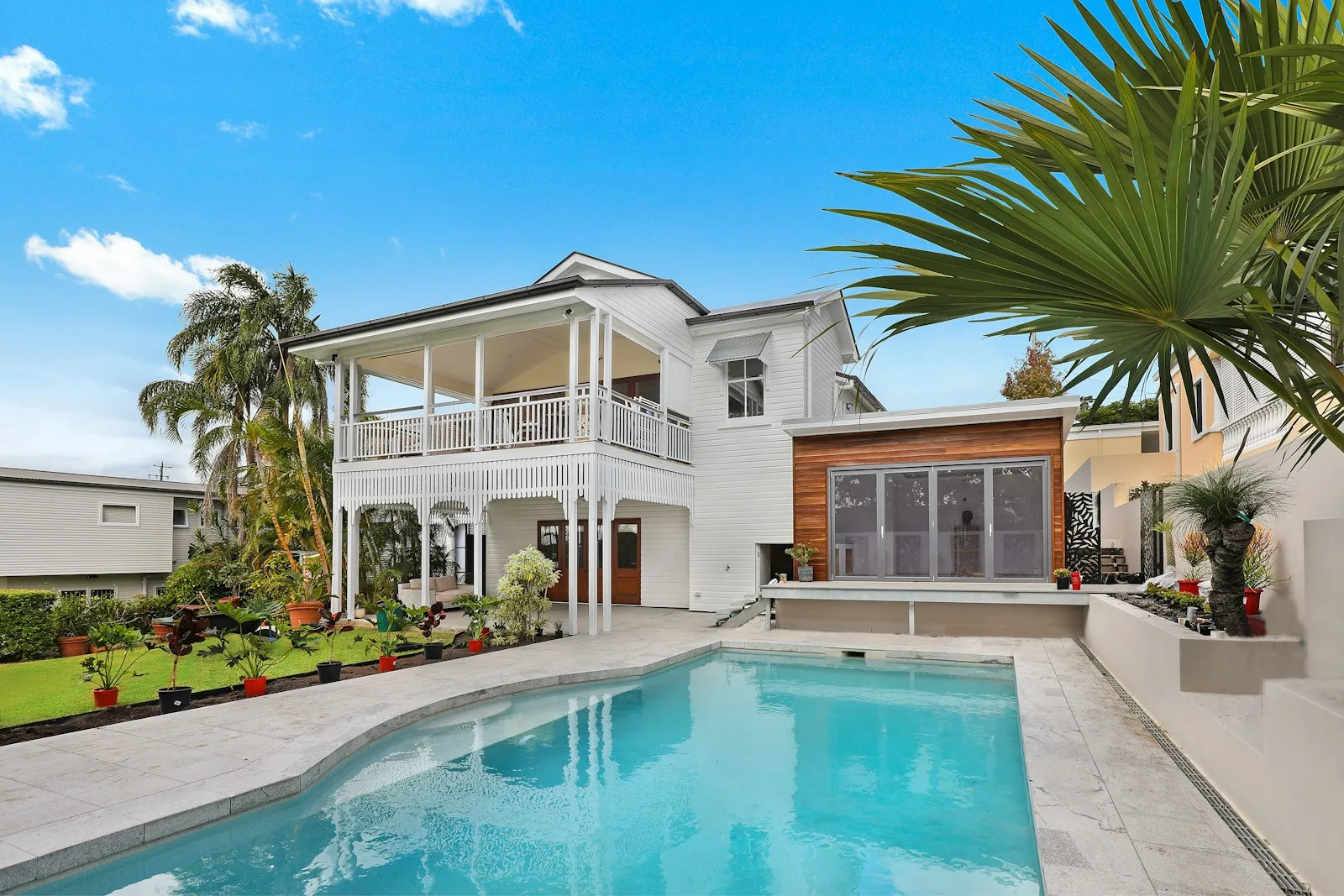 Estate home with a pool and tennis court